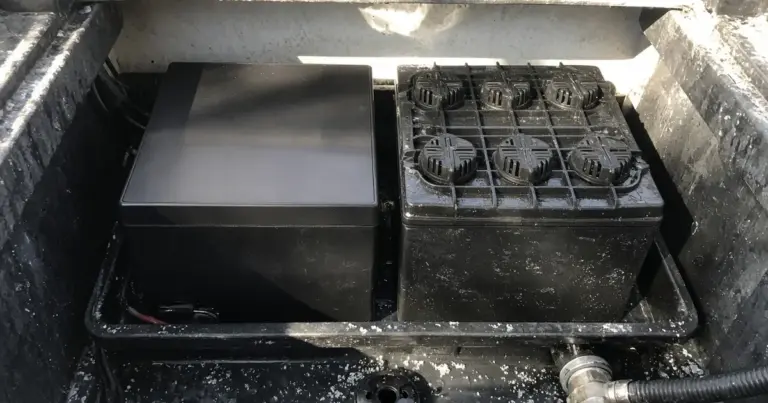 Sealed battery beside a flooded battery with vent caps in a wet boat compartment