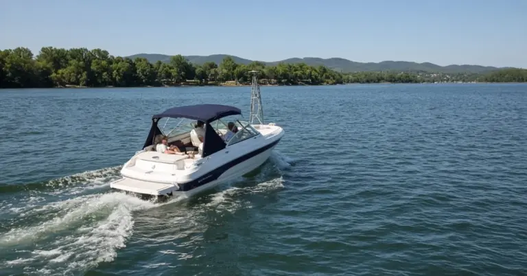 Bowrider boat with a bimini top cruising across a lake
